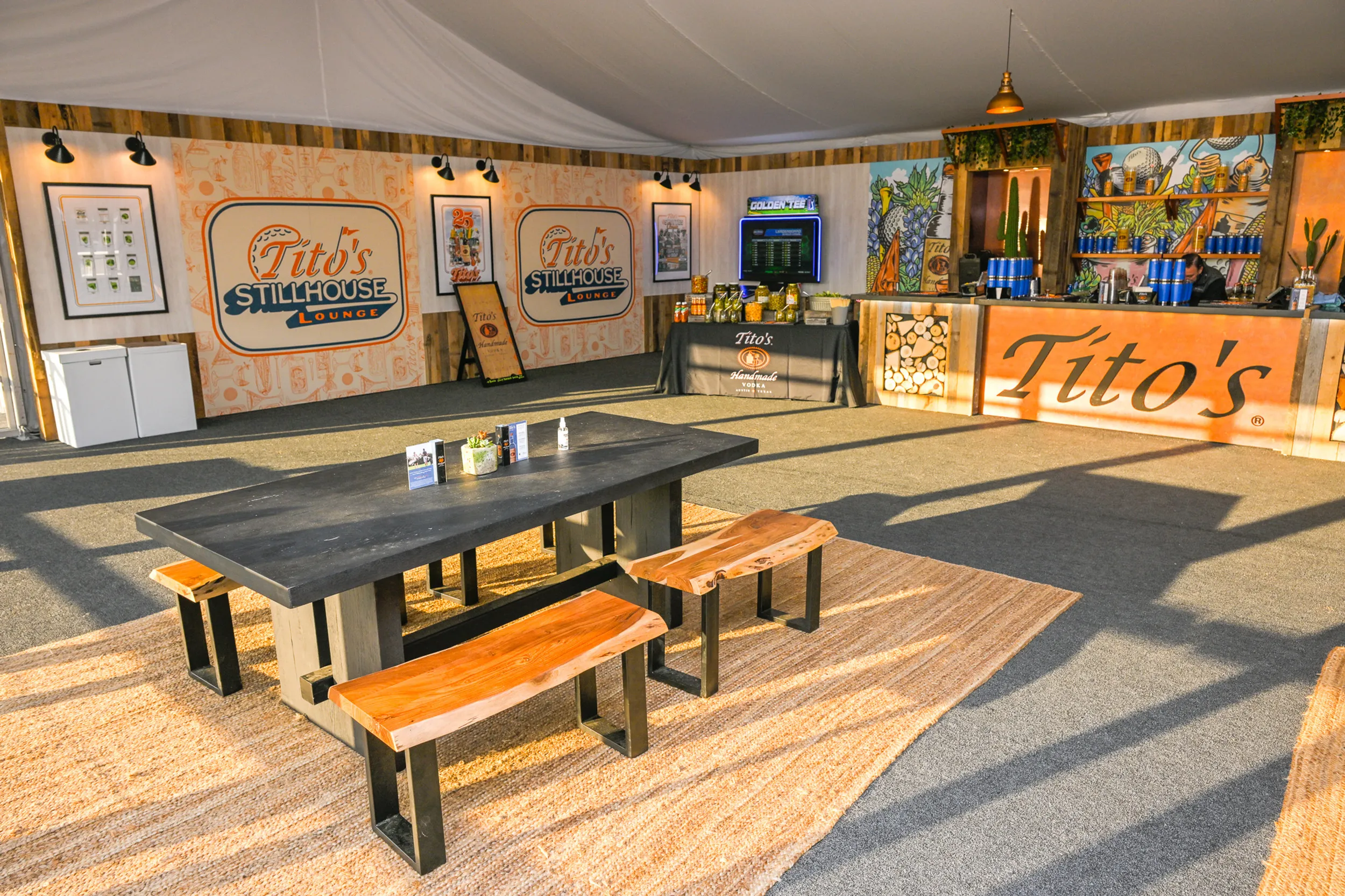Tito's Stillhouse Lounge branded hospitality tent with bar and seating